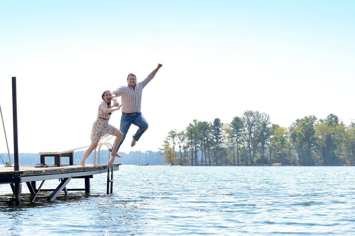 Jumping into water from a dock engagement pictures in Columbia, SC